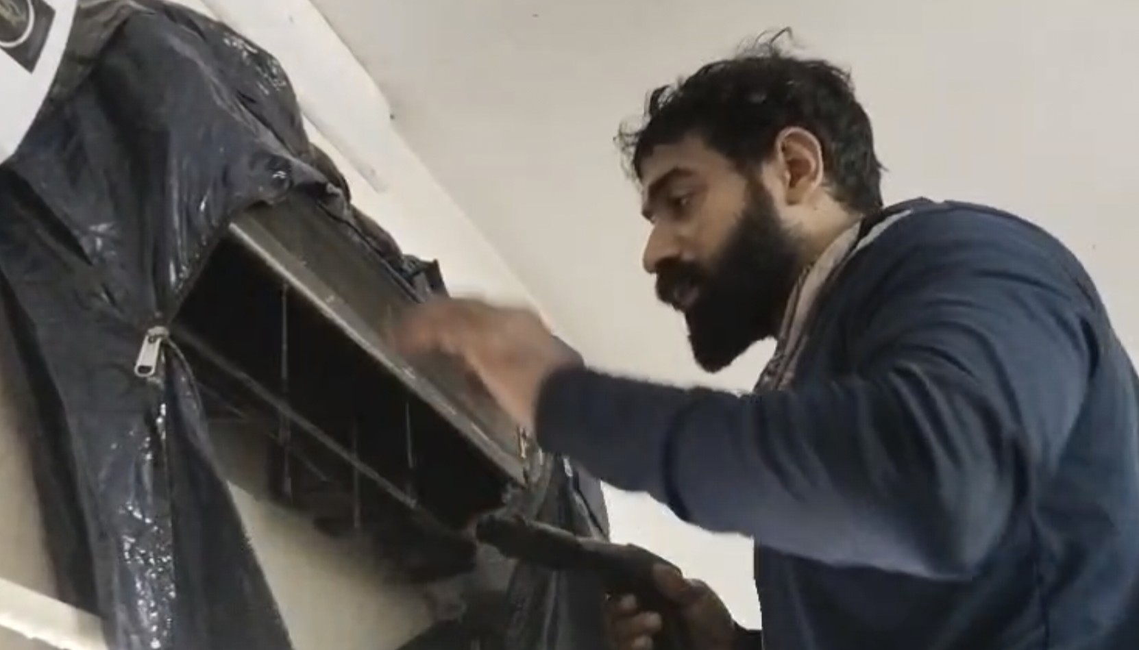 Robin Perfect Cool AC technician servicing a split AC unit in Thrippunithura Kerala
